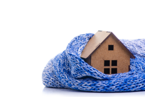 Wooden model house draped in blue scarf