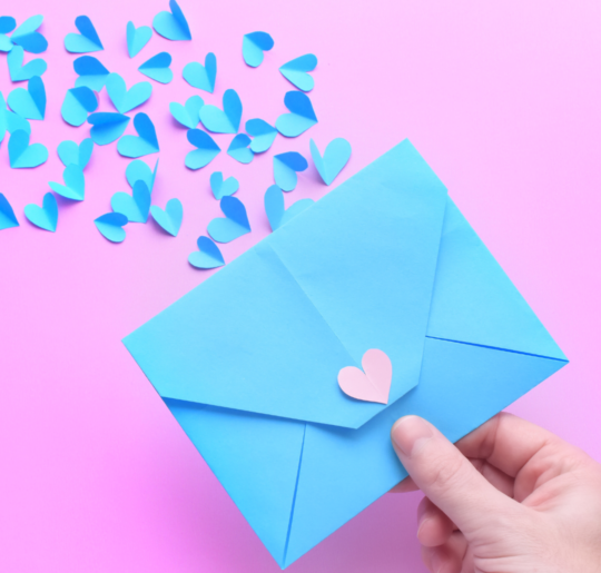 Blue envelope, pink background with flying blue paper hearts